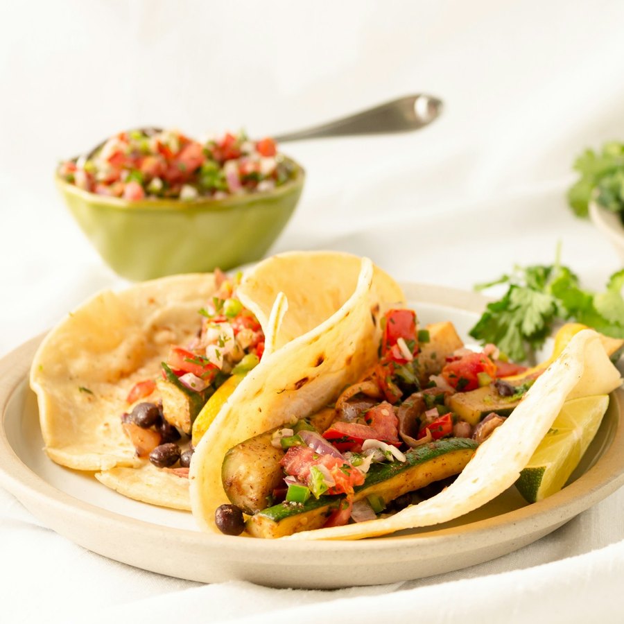 Zucchini and black bean tacos with fresh tomato salsa and lime.